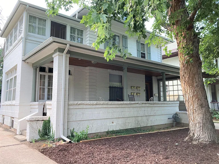 Sweeping front porch to enjoy some fresh air, and visit with friends and neighbors.