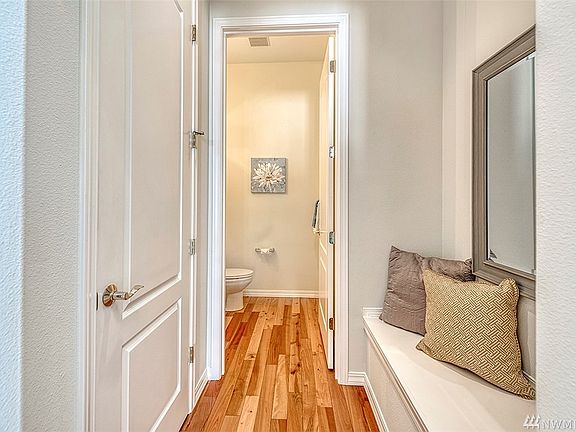 The powder room, coat closet and bench seat are conveniently located just inside the front door.