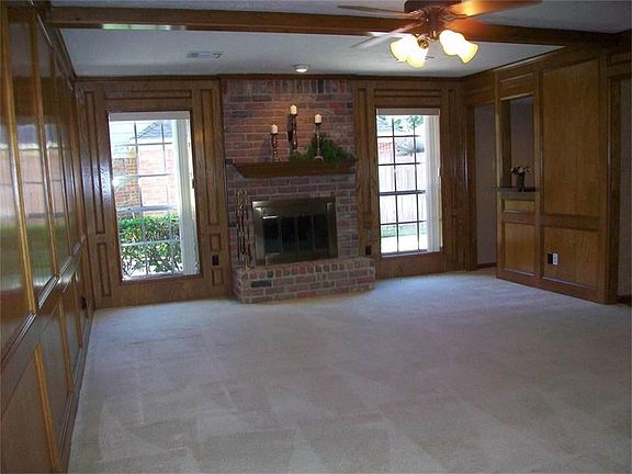 A COZY MASONRY FIREPLACE WITH A HEARTH TO SNUGGLE NEXT TO