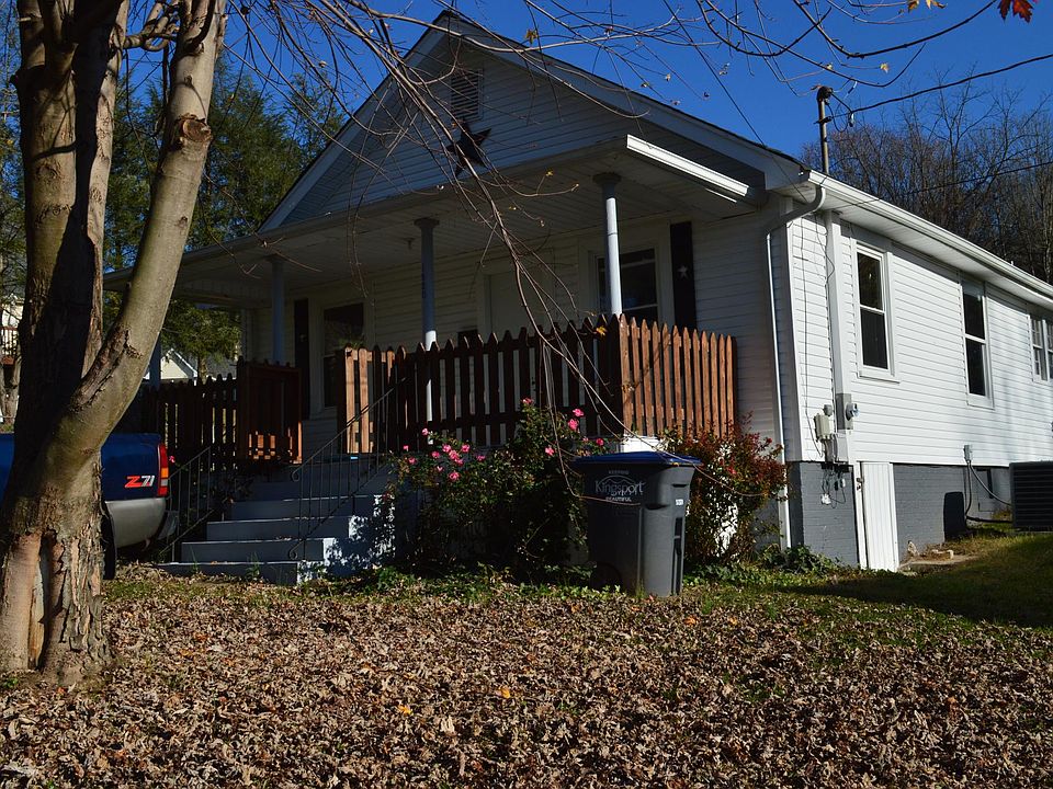 Font of house and a big front porch with gate.