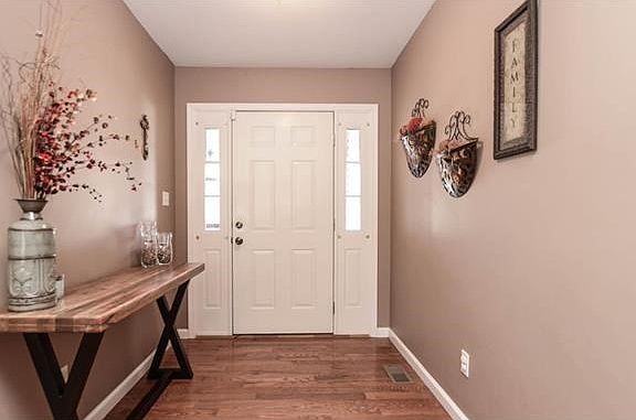 Charming entryway with rich, warm wood floors