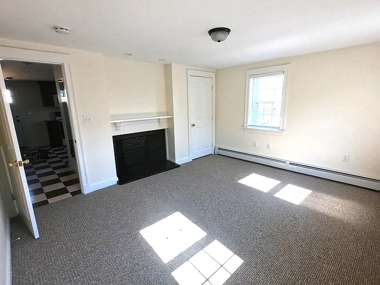Bedroom with decorative fireplace and lighting.