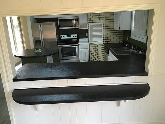 Dining Room eating bar and open serving area with full view of New kitchen Appliances