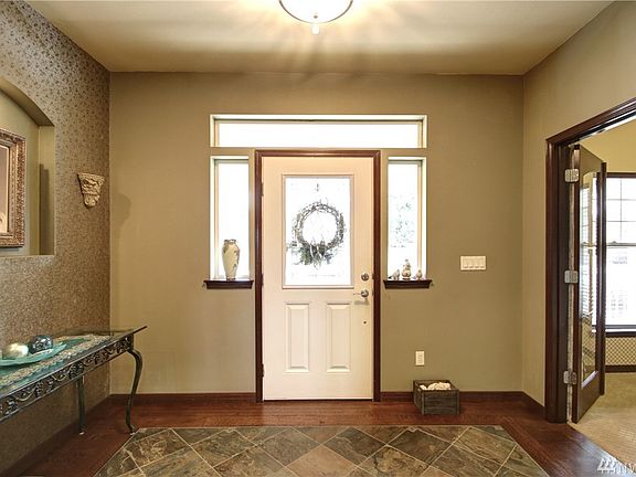 Main entry of home has beautiful slate floors inlay-ed into the hardwoods. French doors open into the private office or study.
