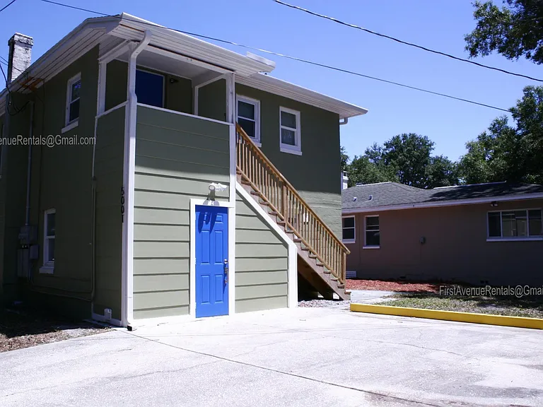 Side view of the carriage house, lower apartment parking on right side of parking pad, easy access from alleyway. Main house has separate parking area. Plenty of on street parking