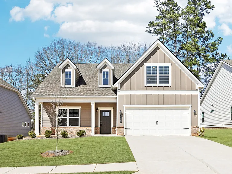 Exterior of the Melrose, two story home with a private driveway and attached garage.