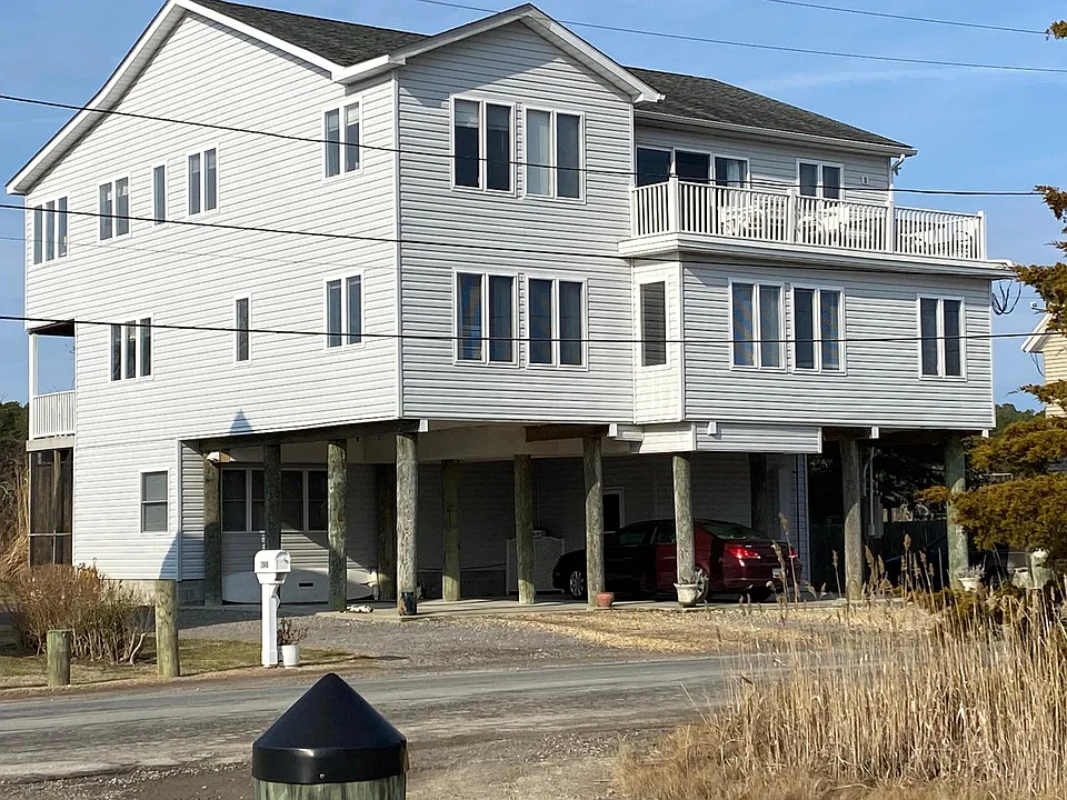 Front of apt w/ windows under parking area w/ water views