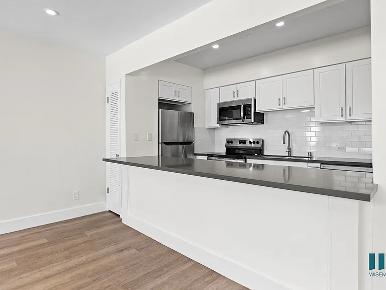 Kitchen with Energy-Efficient Appliances and Countertop Bar