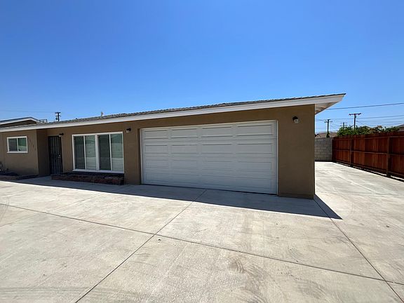 Front of Unit Two car garage and parking on the right