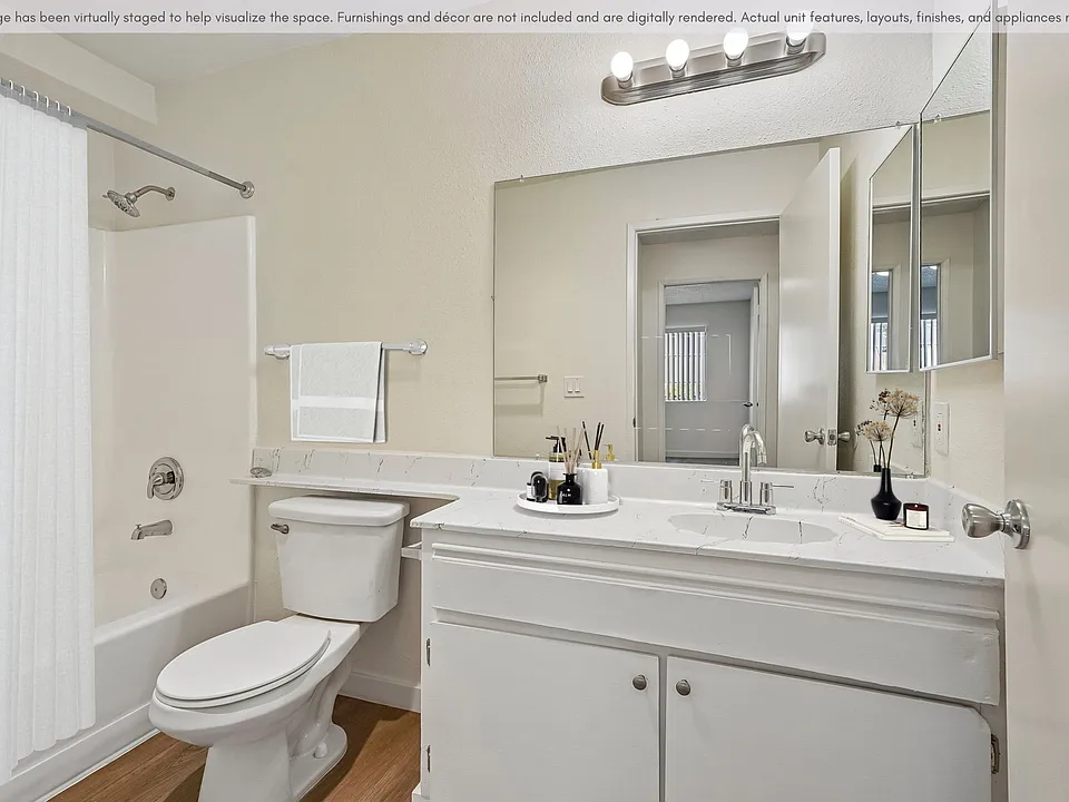 Bright, refreshed bathroom with updated finishes, modern lighting, and a full tub/shower combo.