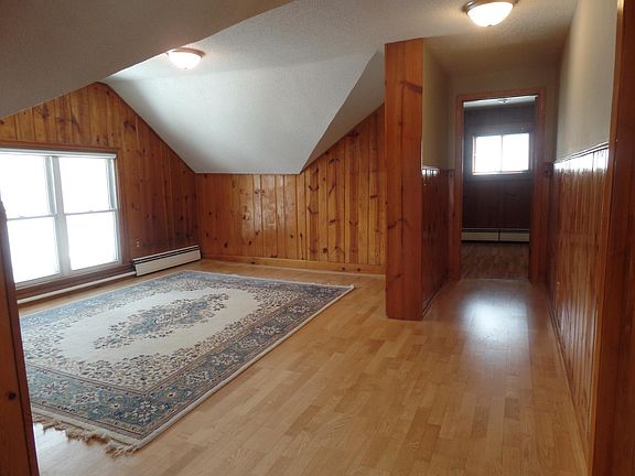 Living Room with hardwood floors, knotty pine and skylight. 