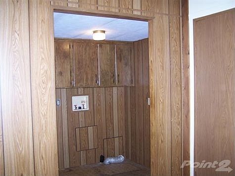 The utility room is large, just off the kitchen and has a door to the side porch.