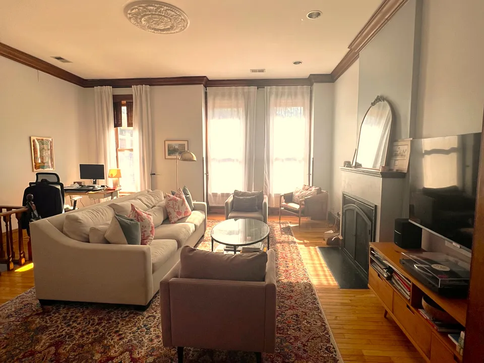 Elegant living room with 3 huge windows and cozy fireplace