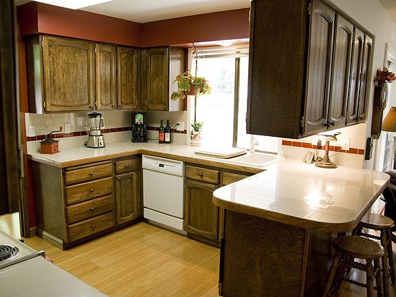 Kitchen with new wood flooring and tile counter/backsplash
