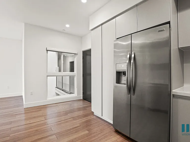 Kitchen with Full-Size Stainless-Steel Refrigerator