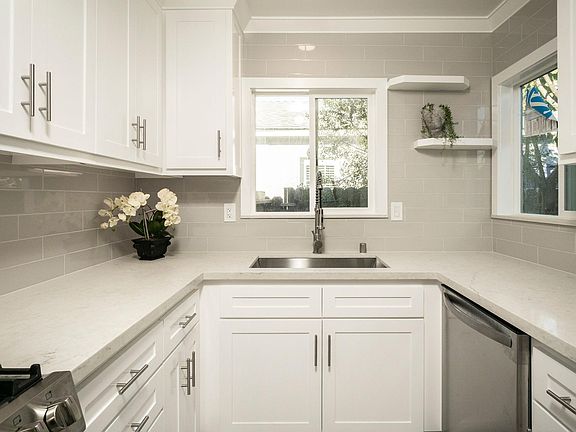 Recently remodeled kitchen with range, dishwasher, microwave and fridge