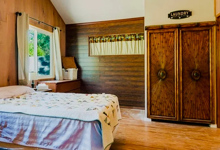 Bedroom has a large windown facing mountain on Hwy 2. This room has the washer/dryer and access to the bathroom.