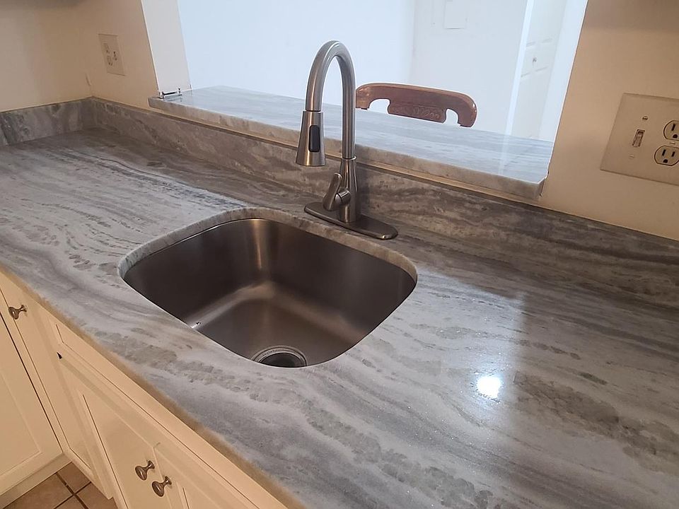 New counter tops. New faucet and new lights over the sink.
