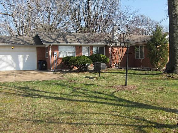 Concrete driveway & patio (behind the bushes) overlook the level back yard. Oversized 2 car rear entry garage.