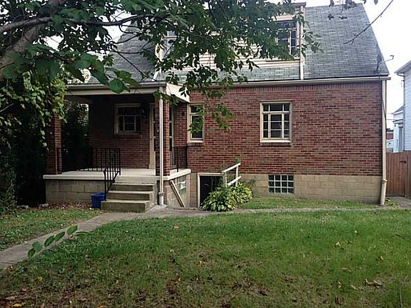 Back with covered porch and entry to basement