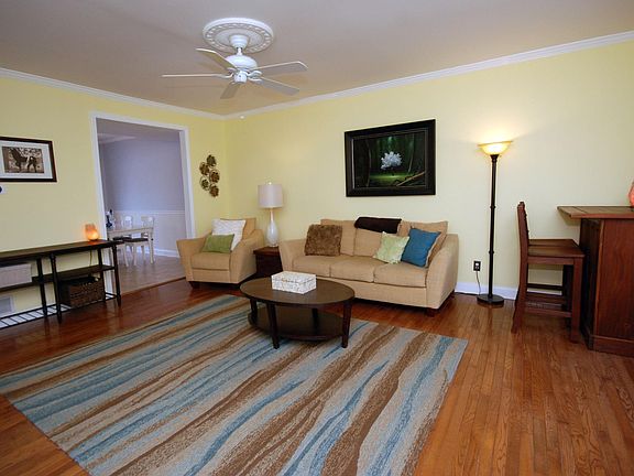 Living Room With Hardwood Floors and Ceiling Fan