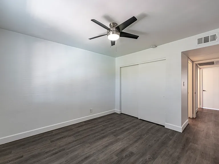 Our bedrooms are both same size in our 2 bedrooms, and feature ceiling fans, wood look flooring throughout, and wall closets for storage.