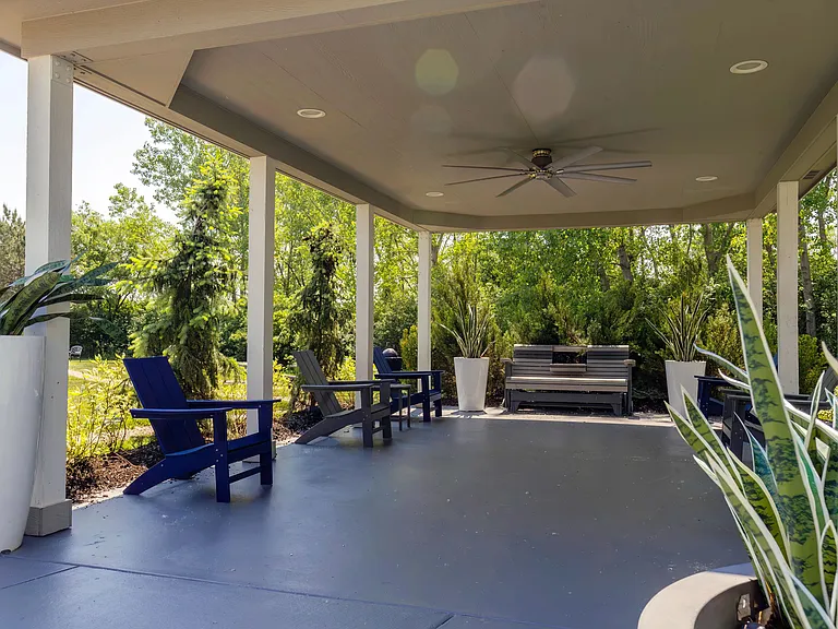 Enjoy an exclusive experience by the outdoor pavilion lounge nestled among trees, offering a private, picturesque escape.