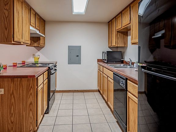 Kitchen with refrigerator, freezer, dishwasher, oven, and microwave.