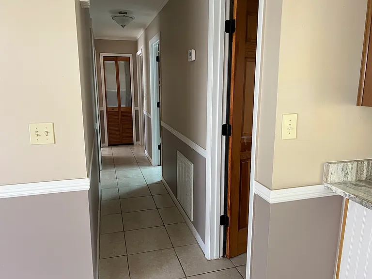 Hallway, linen closet straight ahead at the end