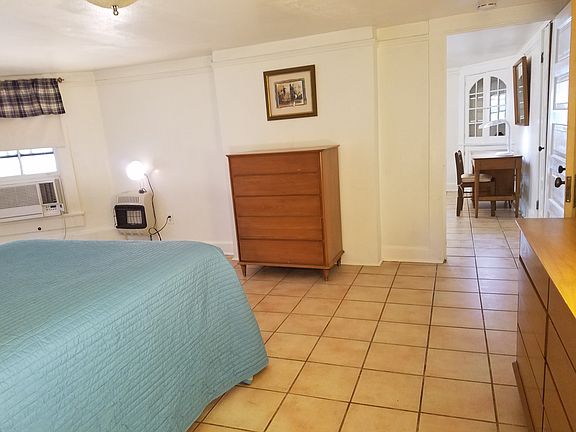 Bedroom shown as furnished. Doorway lends to living room.