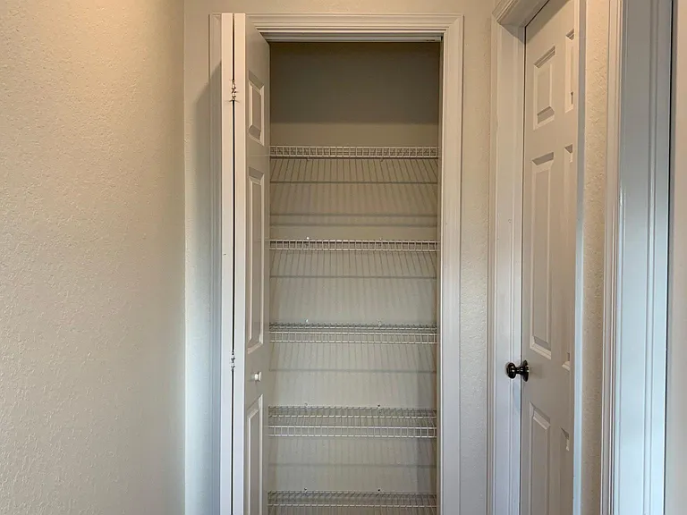 Linen closet off bedroom 3