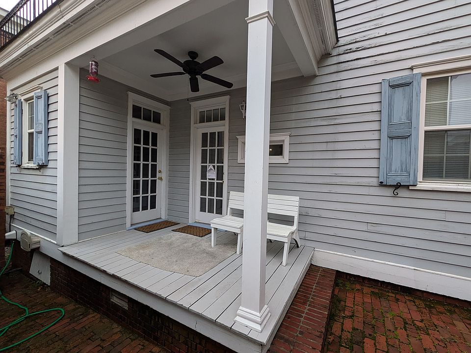 Front door with a porch. Plenty of space on the brick patio to grill.