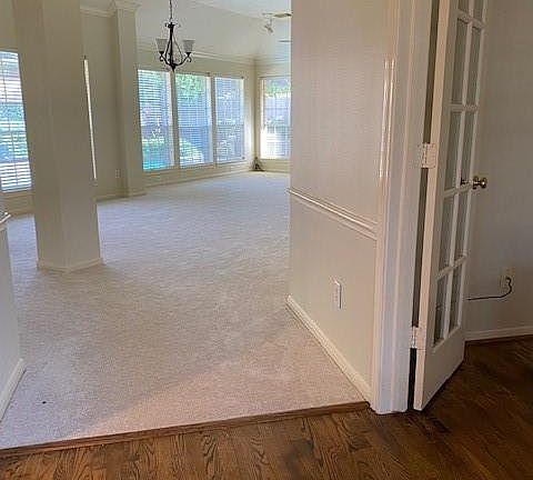 Step into the wood floored foyer leading into the dining / living room.