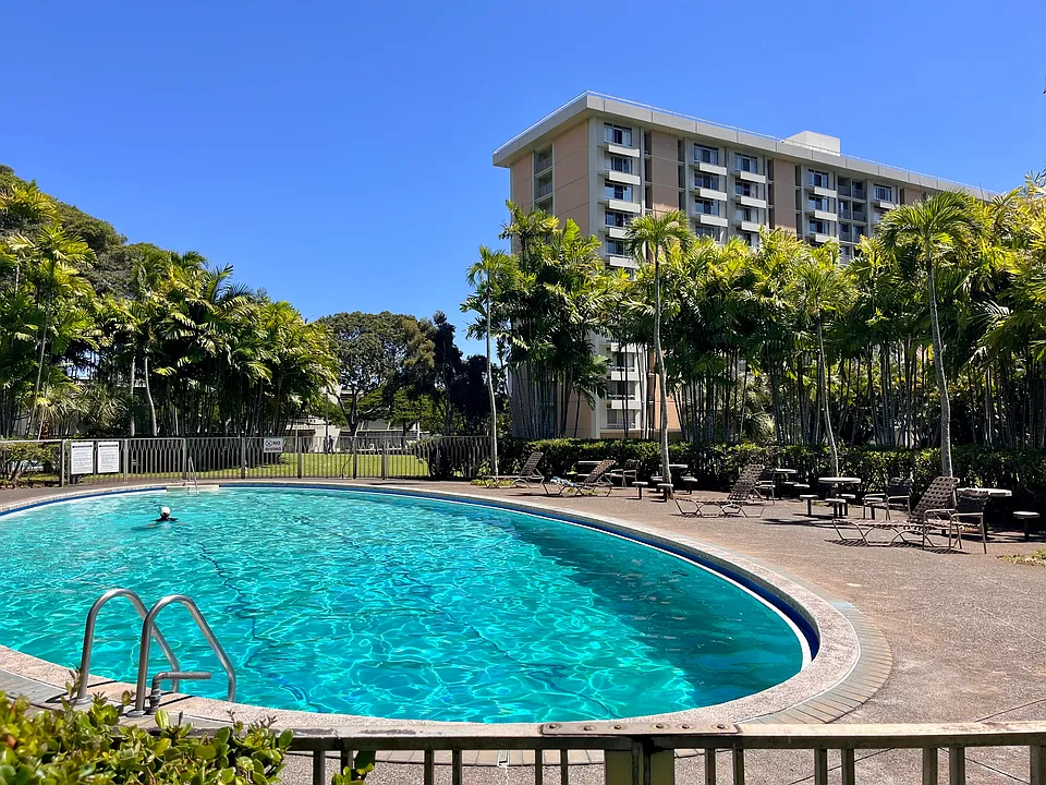 Take a refreshing dip in the sparkling community pool, surrounded by lush greenery.