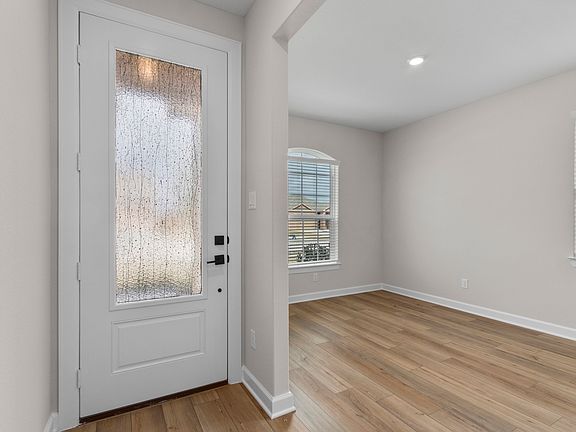 The entryway is highlighted by this gorgeous 3 4 lite door!