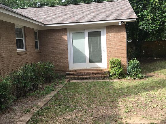 Back of house...Master bedroom has doors leading to the back yard.