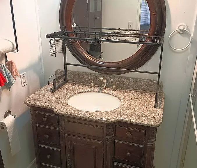 BATH HUGE GRANITE SINK WITH DISH RACK TO WASH YOUR DISH AND LET DRY HUGE BEVELLED ROUND MIRROR WITH LOTS OF LIGHTING KOHLER TOILET BIG SHOWER THAT HAS 2 SEATS TO TAKE BATH.