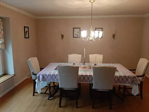 Formal dining room with a view on te left to the front lawn