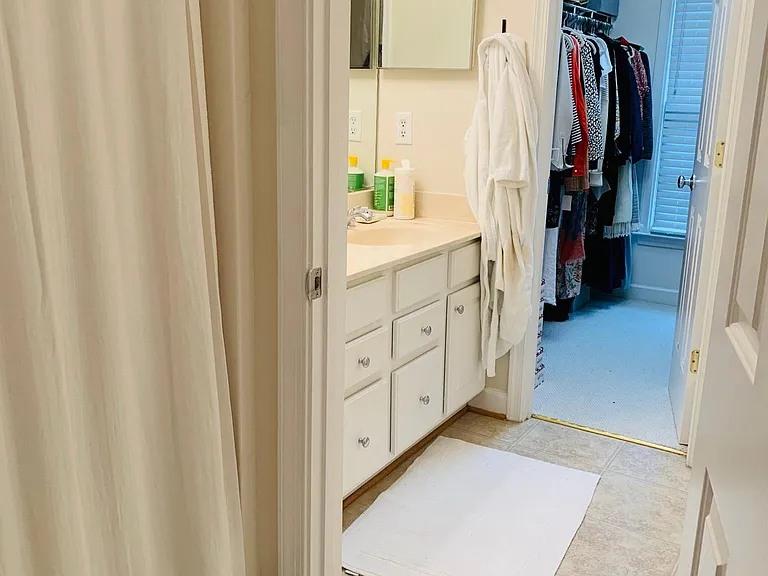 Large walk in closet and separate vanity area with two sinks in master bath