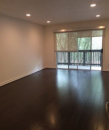 Living room opens to balcony. Picture taken prior to tenant move in.