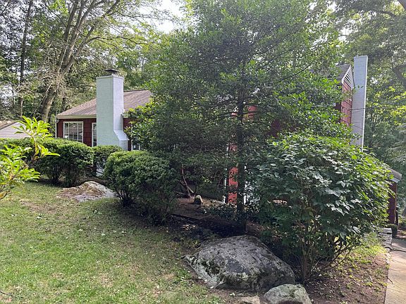 Front yard and front of house with lots of greenery.
