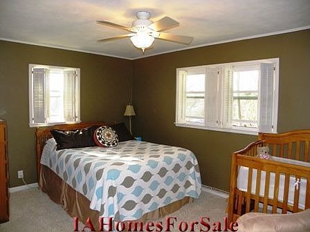 Master Bedroom with beautiful hardwood floors under the carpet (no tack strip marks) great closet with storage above as well and plantation shutters.