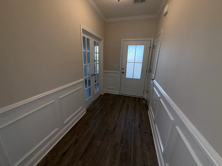 Foyer from Covered Porch with Coat Closet and Doors to Office/Study. Upgraded Moldings