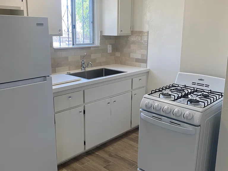 Charming kitchen with new appliances, new countertop and backsplash