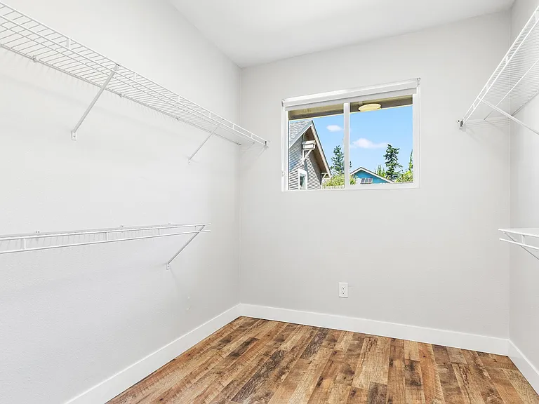 Primary bedroom walk-in closet