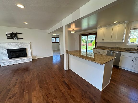 Living area, door to laundry room and sliding glass door to backyard.
