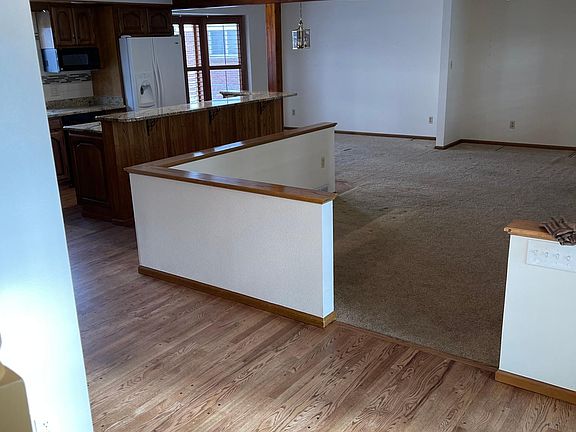 View from front door into large living area and dining room.
