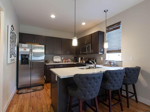 Kitchen with bar top seating and beautiful hardwood floors