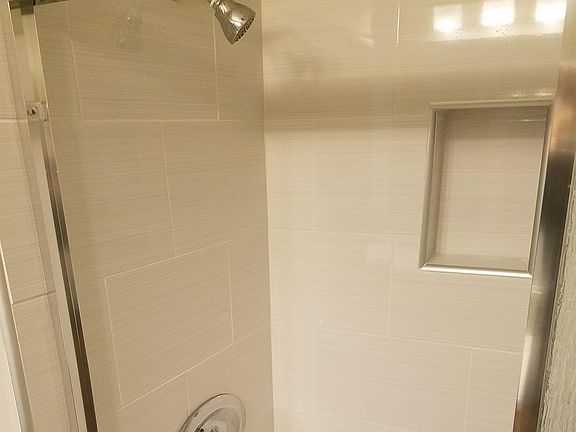 New tile in shower/tub w/ new fixtures.