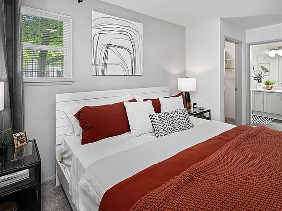 Walk-in closet and large windows in main bedroom